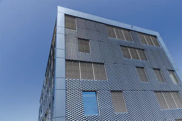Wall cladding with expanded metal panels