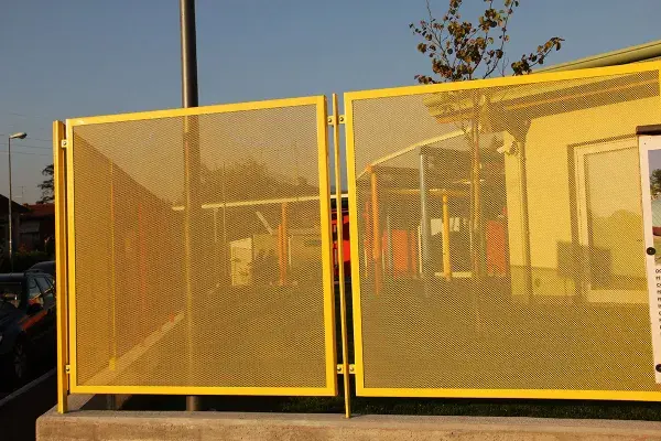 Yellow-painted expanded metal fence panels